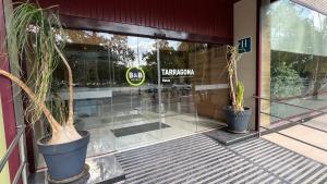a store front with two potted plants in front of it at B&B HOTEL Tarragona Reus in Reus