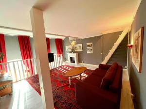 a living room with a couch and a table at Centrally-located Unique Private apartment with 3 floors in Smedjebacken