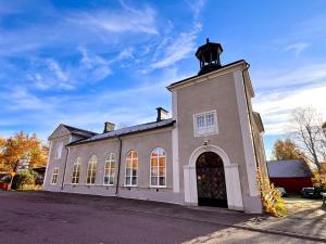 a building with a clock tower on top of it at Centrally-located Unique Private apartment with 3 floors in Smedjebacken