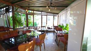 a dining room with tables and chairs and windows at Grand Elite Cave Suites in Goreme