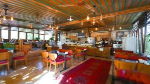 a restaurant with tables and chairs and a kitchen at Grand Elite Cave Suites in Göreme