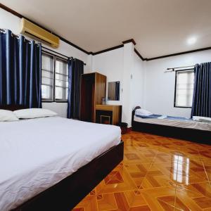 a hotel room with a bed and a bed istg at vangvieng SCK Hotel in Vang Vieng