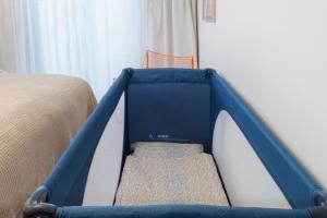 a blue and white bed in a bedroom at Design-Apartment am Chiemsee in Rimsting +34 photos