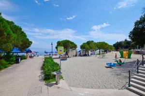a park with a playground and people on the beach at Apartment Miriam in Ika