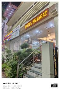 a hotel synergyeat sign in front of a building at Hotel Swaagat in Agra +13 photos