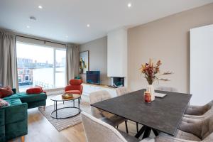a living room with a table and chairs at New 2-Bed Home with Garden Near Google Dublin HQ & Train Station in Dublin