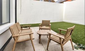two chairs and a table on a patio at New 2-Bed Home with Garden Near Google Dublin HQ & Train Station in Dublin