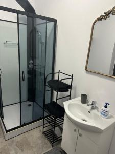 a bathroom with a shower and a sink and a mirror at Home No 7 