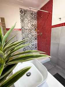 a bathroom with a white sink and a shower at Dung Beetle Bush Villa in Marloth Park +22 photos