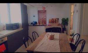 a kitchen with a table and chairs in a room at appart kelibia a 10 minutes d une belle plage el fatha in Kelibia