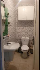 a bathroom with a toilet and a sink at Sony in Kelibia
