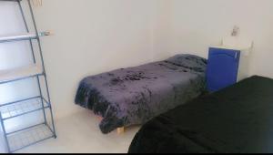 a small room with two beds and a ladder at Sony in Kelibia