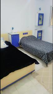 a bedroom with two beds and a counter at Sony in Kelibia