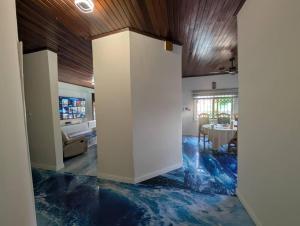 a living room with blue floors and a dining room at Bendo house in Accra
