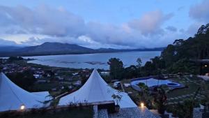 a view of a lake from a marquee at Adelisca Glamping, Cafe and Villa in Kubupenlokan
