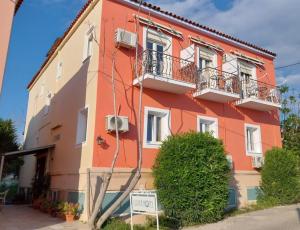 a colorful building with a sign in front of it at Ulrika in Aegina Town