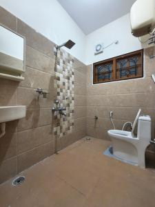 a bathroom with a toilet and a sink at Flickstays Elara in Bangalore