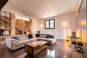 a living room with a couch and a table at Mas Sureda Soccer field & indooroutdoor pools in Argelès-sur-Mer