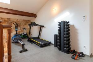 a room with a gym with a treadmill and weights at Mas Sureda Soccer field & indooroutdoor pools in Argelès-sur-Mer