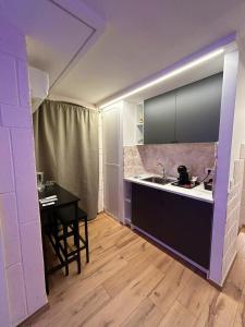 a kitchen with a sink and a table in it at Claustro Segreto - ALTAMURA in Altamura