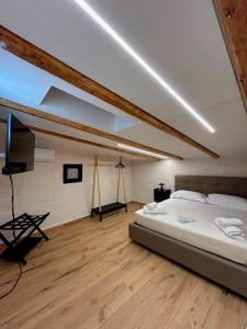 a bedroom with a bed and a flat screen tv at Claustro Segreto - ALTAMURA in Altamura