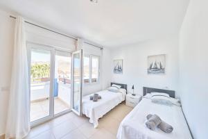 a bedroom with two beds and a balcony at Villa Joya I in San José +43 photos