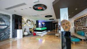 a lobby of a store with a giant head on the wall at Evenia Rocafort in Barcelona +23 photos