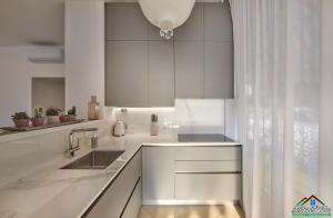 a kitchen with white counters and a sink and a window at APT in Villa Bianca with Pool and air conditioning in Lierna
