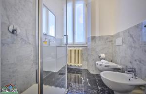 a bathroom with a shower and a toilet and a sink at APT in Villa Bianca with Pool and air conditioning in Lierna