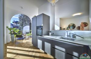 a kitchen with a sink and a counter top at APT in Villa Bianca with Pool and air conditioning in Lierna +31 photos