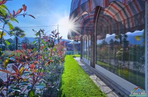 an exterior view of a building with a garden at APT in Villa Bianca with Pool and air conditioning in Lierna