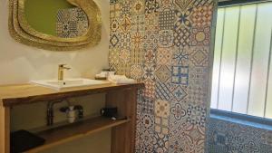 a bathroom with a sink and a mirror at Maisonnette du Foirail in Espalion +12 photos