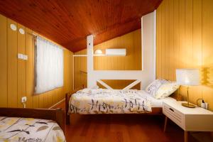 a bedroom with two beds and a table with a lamp at Kuća za odmor Miha in Tar
