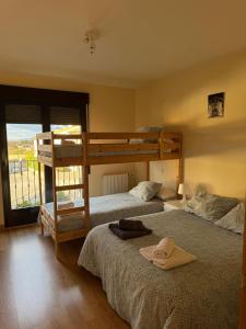 a bedroom with two bunk beds and a balcony at Mirador de Peña La Estrella in Ortigosa del Monte +101 photos