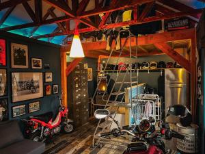 a room with a room with motorcycles in it at Le Garage - logement insolite à 2 pas de Lille in Sainte-Marguerite