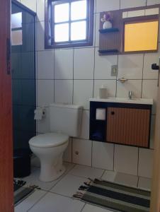 a bathroom with a toilet and a sink at Chalé da Lili in Nova Friburgo +22 photos