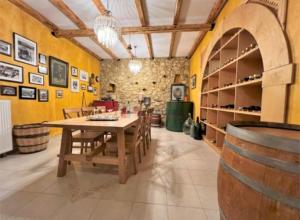 a dining room with a table and chairs and a wine cellar at Onirozo Koroni Private Villa in Koroni
