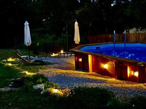 a swimming pool with lights in a backyard at night at Casa Vacanze Al Fontanile in Santa Fiora