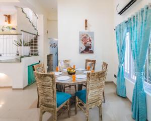 a dining room with a table and chairs at Villa Sylvana By Bluewave Hospitality in Nagoa-Bardez
