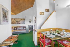 a living room with a table and a couch at Il Balcone Sulle Alpi ski in ski out - Happy Rentals in Sauze d'Oulx