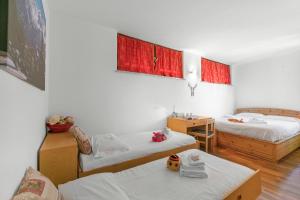 a small room with two beds and a table at Il Balcone Sulle Alpi ski in ski out - Happy Rentals in Sauze d'Oulx