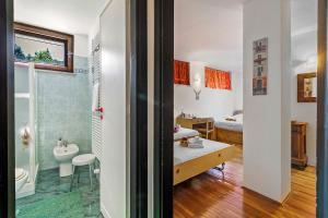 a bathroom with a sink and a toilet in a room at Il Balcone Sulle Alpi ski in ski out - Happy Rentals in Sauze d'Oulx