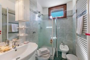a bathroom with a sink and a toilet and a shower at Il Balcone Sulle Alpi ski in ski out - Happy Rentals in Sauze d'Oulx +13 photos