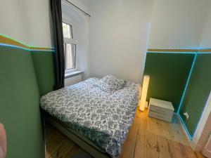a small bedroom with a bed and a window at The Cozy Green in Berlin