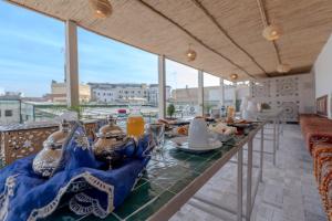 a table with food and drinks on a balcony at Riad Al Mozyane in Fez