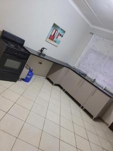 a kitchen with an open refrigerator and a stove at Nestville apartments in Solwezi