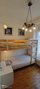 a bedroom with two bunk beds and a chandelier at Maison spacieuse avec jardin à Cabourg, 250 m² in Cabourg +36 photos