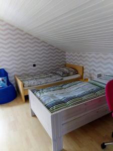 a bedroom with two beds in a room at Panoramablick Donnersberg in Dannenfels