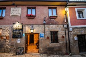 an old brick building with a sign on it at La Cachava in Castrojeriz +16 photos