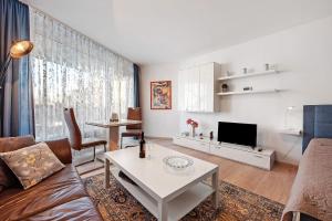 a living room with a couch and a table at Fewo Jutta in Oberuhldingen